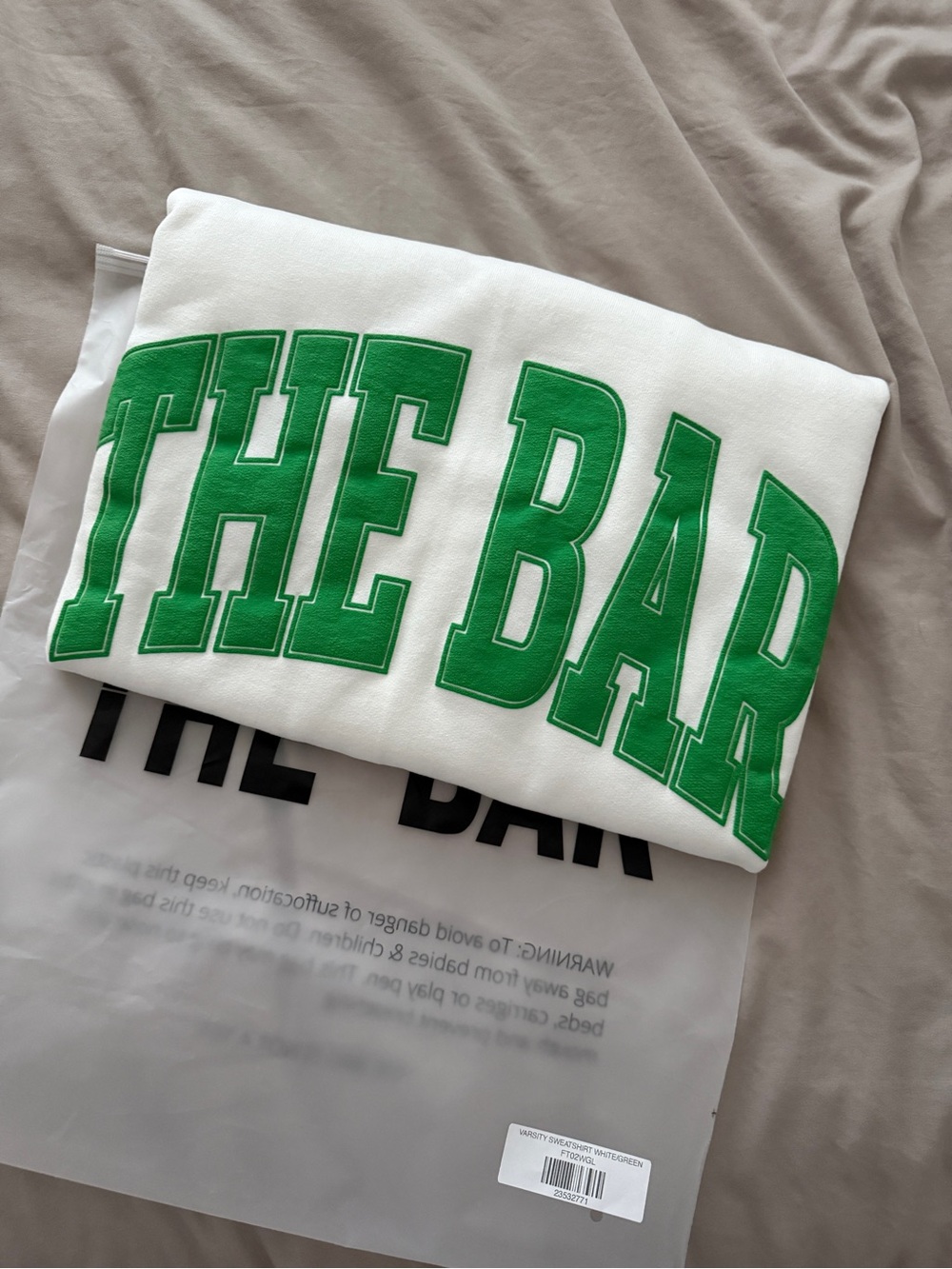 White Sweatshirt with Bold Green 'THE BAR' Lettering